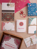 VesperLane Mega Plantable Rakhi Gift Kit — 10-piece seed paper stationery flat lay: mandala colouring book, notebook, cards, envelopes, bookmarks