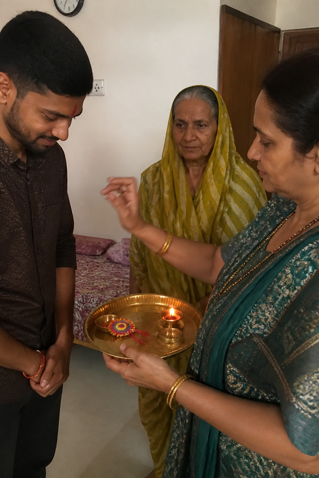 Family performing aarti during Raksha Bandhan