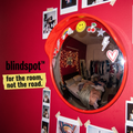 Blindspot convex mirror on a red bedroom wall with stickers