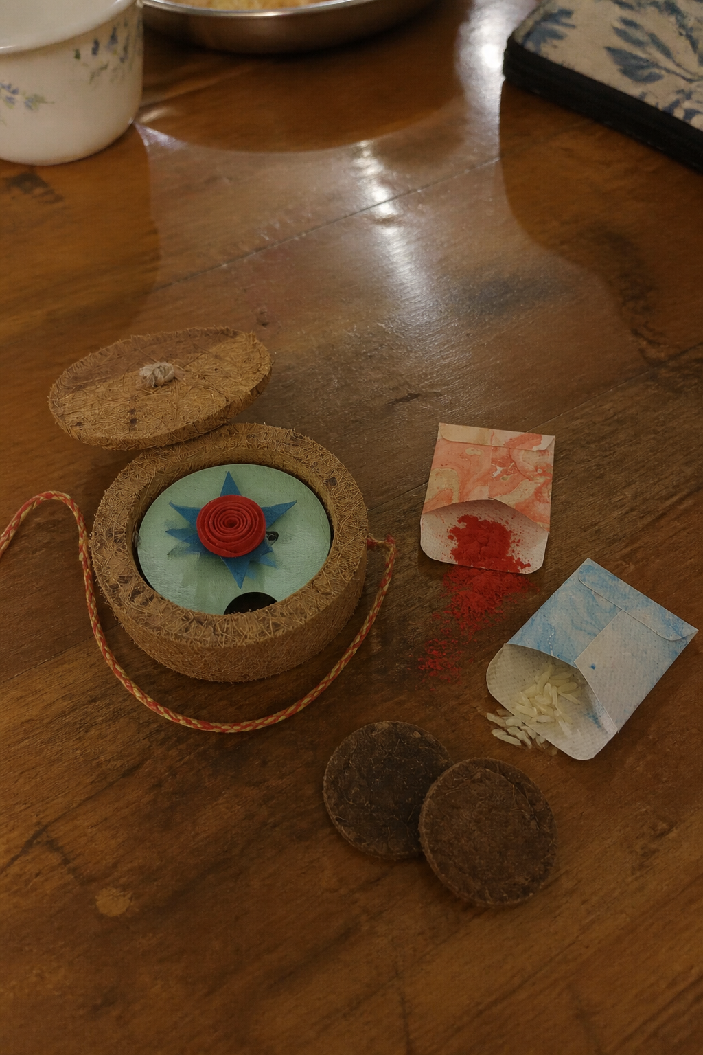 The Rose Rakhi Kit contents laid out — rakhi, coir pot, roli-chawal pouches, cocopeat and cow dung coins